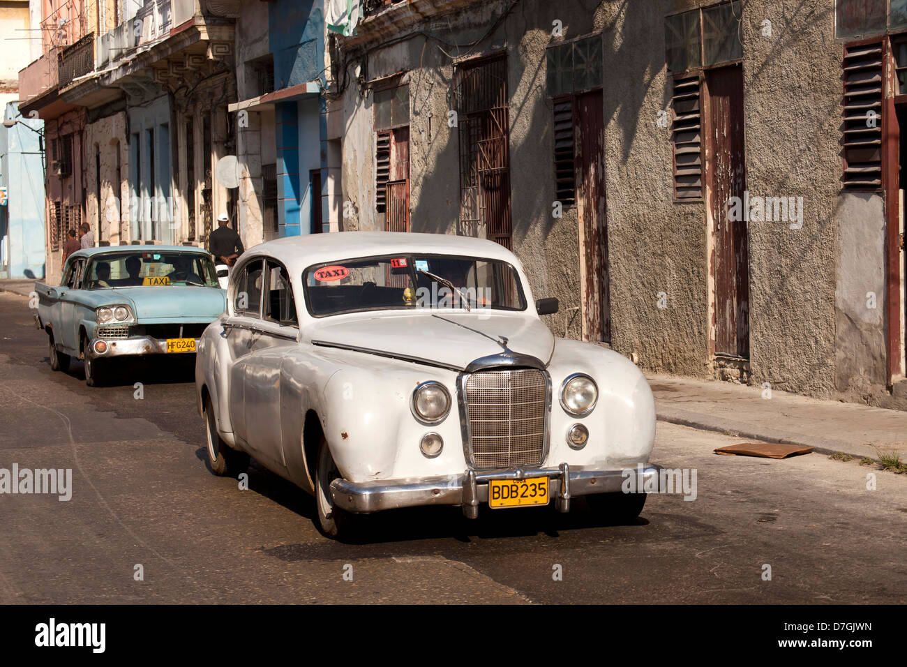 vintage US cars from the 50`s and coulourful buildings in Centro Habana, Havana, Cuba, Caribbean Stock Photo